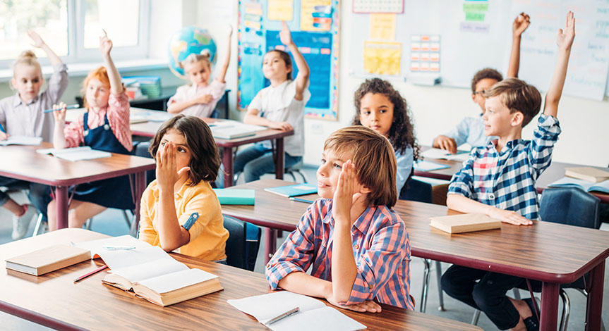 kids raising hands in class